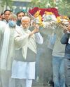 Bereaved Modi opens train link, chairs meet