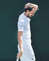 Medvedev bites the grass, Alcaraz scrapes through65