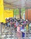 Students attend classes under tarp; govt school awaits funds Students attend classes under tarp; govt school awaits funds9