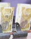 Rupee hits new low of 84.96 on merchant dollar bids