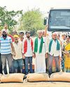 Ryots block road with paddy bags Ryots block road with paddy bags