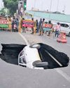 Sinkhole in middle of Taramani & Thiruvanmiyur road 'swallows' car Sinkhole in middle of Taramani & Thiruvanmiyur road 'swallows' car