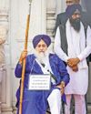 'Sewadar' Sukhbir, on wheelchair & with plaque around neck, at Golden Temple