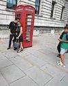 Tourists hanging on for iconic red phone box snaps1