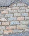 Stone me! Time warp Victorian cobbled street revealed under large pothole