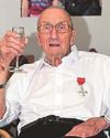 War hero Geoff wears his new MBE medal on 100th birthday37