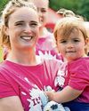 Nikki celebrates with tot Abbie as she fires gun for Race for Life40