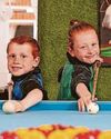 Pocket-sized pool player taking on teen opponents5