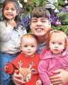 Teenage lad who helps look after 13 little ones