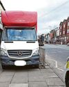 Dozy parker blocks shop and crossing with van