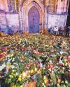 Candles lit and a sea of flowers laid by a city in shock