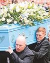Grieving Claire says a tearful farewell as 'people's champ' is laid to rest3