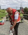 Pair are rescued from canal lock after venturing in to save dog
