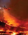 Pause in fierce winds helps.Los Angeles wildfire crews.