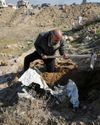 Bereaved Gazans dig out bodies from city ruins, give them graves