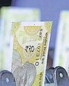 Rupee closes at record low hurt by weak yuan, rise in US bond yields