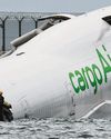 Cargo plane slides off runway in Hong Kong, killing two airport staff13