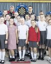 Primary pupils sharpen their number skills with youth darts champion Gian0